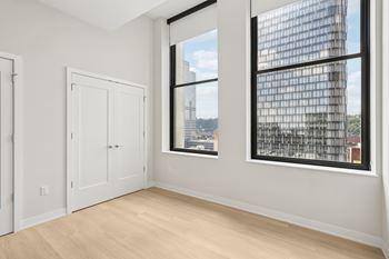 A room with a large window and a view of a cityscape. at LiveWell Apartments, Pennsylvania, 15222